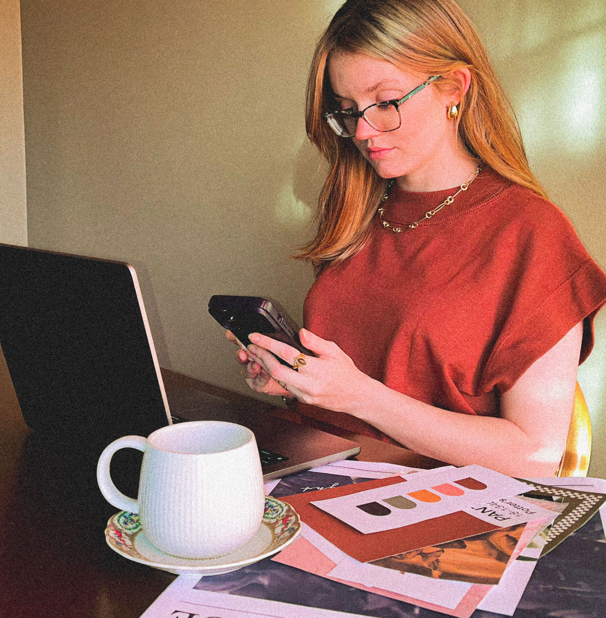 small local business owner sitting at a table with her phone